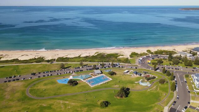 Aerial drone pullback reverse view of Cronulla looking toward Wanda Beach in the Sutherland Shire, Sydney, NSW Australia on a sunny day in June 2023 