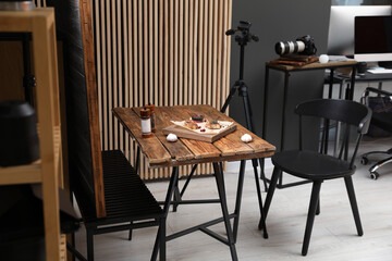 Professional equipment and composition with delicious meat medallions on wooden table in studio. Food photography