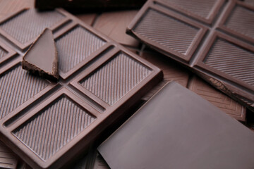 Many tasty chocolate bars as background, closeup