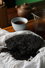 Broken disc shaped pu-erh tea on table