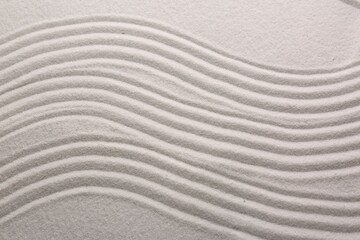 White sand with pattern as background, top view. Concept of zen and harmony
