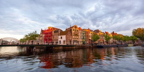 Historic homes at the water front in Leiden city centrum, The city is intersected by numerous small...