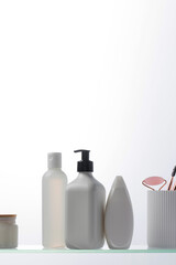 A set of cosmetics for the care and youth of the skin on a glass shelf. Layouts with a place for your logo.