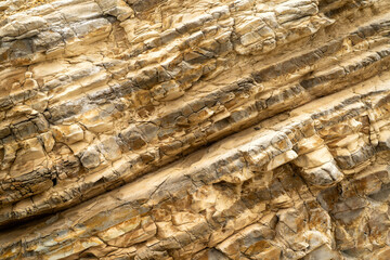 Yellow limestone wall formation on the beach