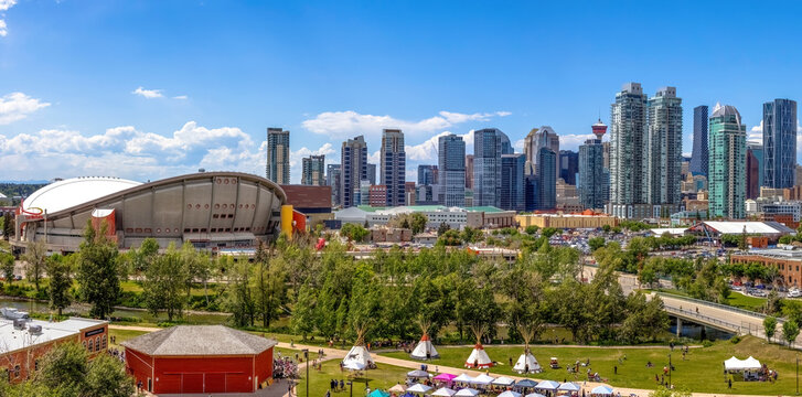Calgary, Alberta, Canada. Jun 20, 2023. Calgary Downtown skyline during summer and Indigenous tipi's on display in the Indian Village with the dow