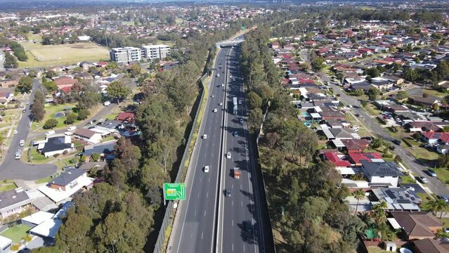 Aerial drone view above the South Western M5 Motorway at Casula in Sydney, NSW Australia looking in the south direction 