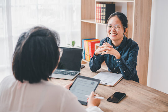 HR managers are interviewing job applicants who fill out their resume on the job application form in order to consider accepting a job as a company