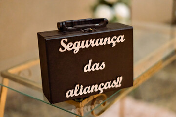 a black briefcase written in white letters "alliance security"