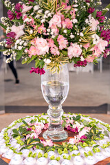 a wedding cake and trays of chocolate brigadeiro on top of a glass table