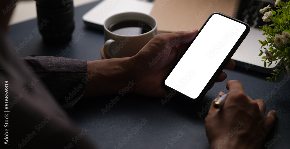 Poster man hands holding smart phone with blank screen for your text message or information content.