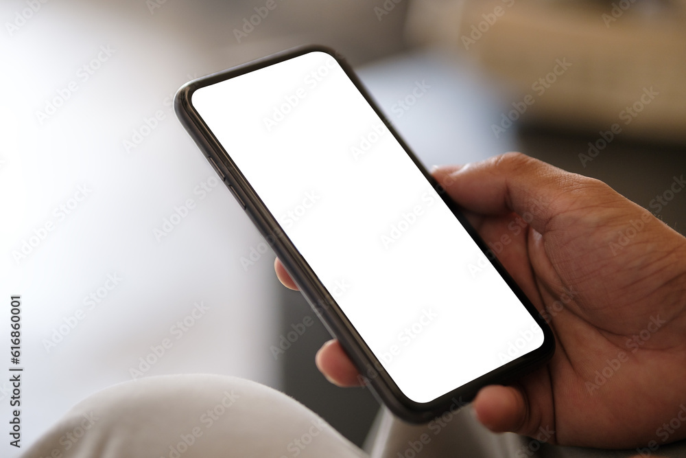Poster closeup view of hands holding smartphone with blank screen and left side with empty space for your a