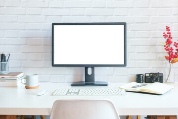 Fototapeta premium Front view blank desktop computer screen, picture frame and pencil holder on white table.