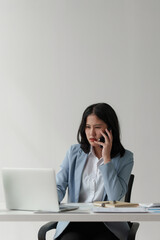 Asian business woman feel stress with works, uses a laptop, makes a report to a finance company. Accounting and financial concept