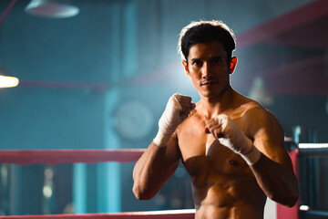 portrait of Asian man boxer having strength body are working out exercise in gym, athlete sportsman fighter male person having strong muscle training active in sport fitness gym for muscular power up
