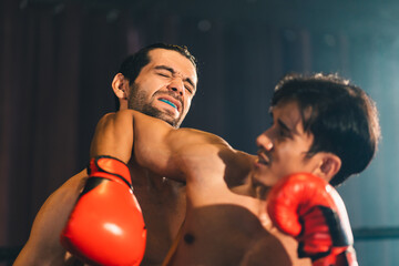 Fototapeta na wymiar Gym atmosphere, Two professional fighters posing on the sport boxing ring. Fit muscular caucasian athletes or boxers fighting, Sport competition and human emotions concept, MMA or Thai Boxing match