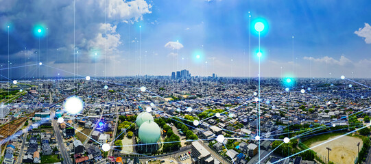 Modern cityscape and communication network concept. Telecommunication. IoT (Internet of Things). 5G. Smart city. Digital transformation. Composite visual with a drone point of view. Mixed media.
