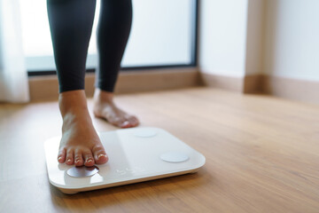 Lose weight. Fat diet and scale feet standing on electronic scales for weight control. Measurement...