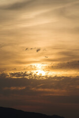 Fototapeta na wymiar 夕焼けと飛行機・離陸後上昇旋回する航空機のある夕焼け空