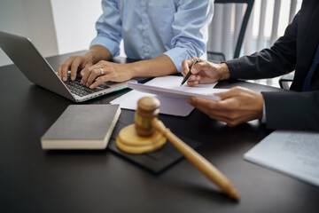 Legal counsel presents to the client a signed contract with gavel and legal law. justice and lawyer...