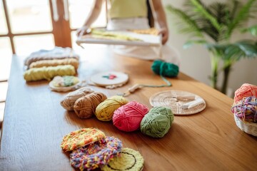 Punch needle. Asian Woman making handmade Hobby knitting in studio workshop. designer workplace Handmade craft project DIY embroidery concept.