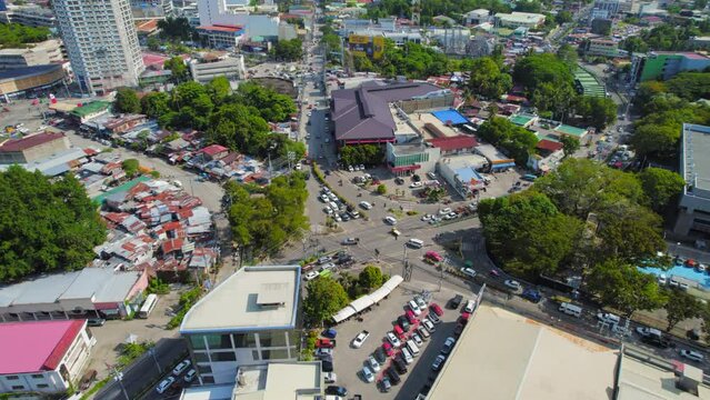 Aerial Drone Cinematic Establishing Shot Of Busy Asian City Intersection With Cars And Motorbikes Driving Through.