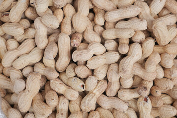 top view of Several peanuts in a basket.