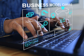 Businessman working with bmc or business model canvas as business process planning on laptop to...