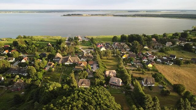 Aerial view from Wieck village on the peninsula Fischland-Dar&szlig;-Zingst in sunset light, with bodden in background