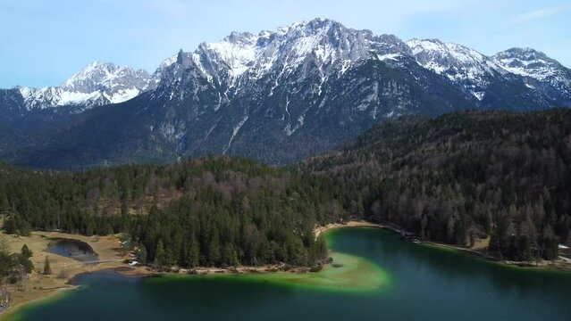 Incoming drone shot, showing the Lauter Lake in summer with Karwendel mountain in the background, very close to the bavarian town of Mittenwald in Germany