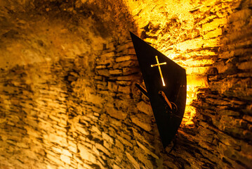 Old light at night hanging on a medieval fortress wall background torch stand or mount