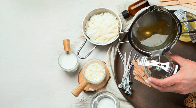 Set for homemade natural eco soy wax candles, Woman making decorative aroma candle at table.