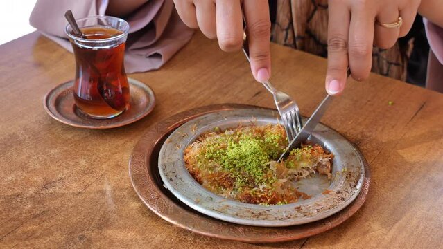 kunafa with a wipe cream on a plate .
