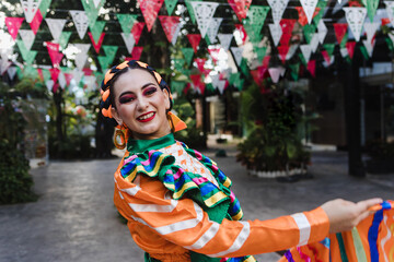Obraz premium Latin woman dancer wearing traditional Mexican dress traditional from Guadalajara Jalisco Mexico Latin America, young hispanic female in independence day or cinco de mayo parade or cultural Festival