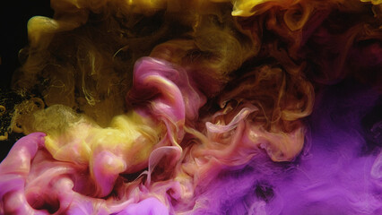 Ink water shot. Color smoke cloud. Fluid mix. Yellow pink purple glowing paint mix splash glitter dust particles on dark black abstract art background.