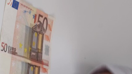 Vertical video. Money investment. Profit value. International trade. Closeup of female hands counting income 50 bill euro cash paper banknotes.