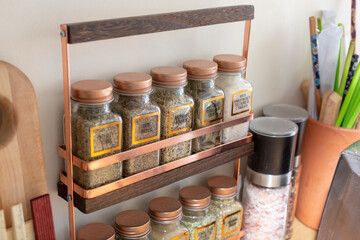A view of a counter spice rack, seen in a home kitchen setting.