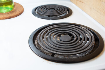 A view of some stove burners on a vintage electric coil range.