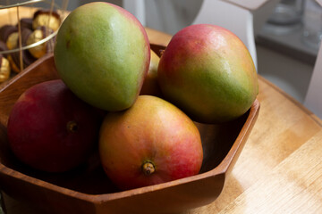 A view of a bowl of mangoes. 