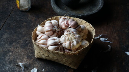 Garlic, fresh garlic,garlic clove, garlic bulb in a wooden basket. Organic garlic is a herb and spice cloves or food ingredients, Healthy food.