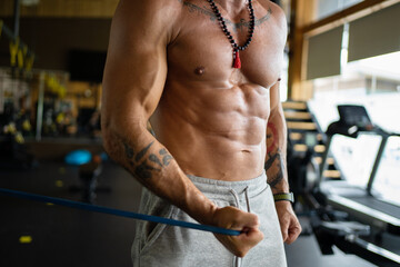 Fit man exercising the arm with an elastic band
