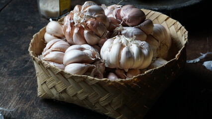 Garlic, fresh garlic,garlic clove, garlic bulb in a wooden basket. Organic garlic is a herb and spice cloves or food ingredients, Healthy food.