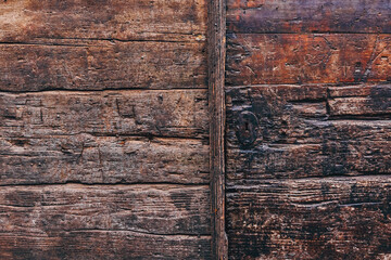Old weathered medieval wooden door gate detail as background