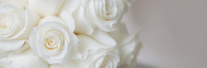 Wedding bouquet of white roses on a white background with soft focus and copy space. Banner for website header design with copy space.