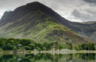 Naklejka na ściany i meble Fleetwith Pike towering over the end of s still Buttermere