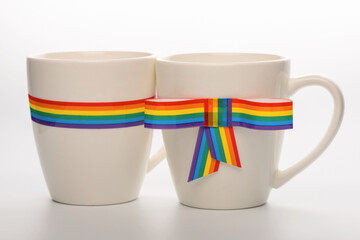 concept gay culture symbol with couple cups and rainbow ribbons bow, sign LGBT community is isolated on white background