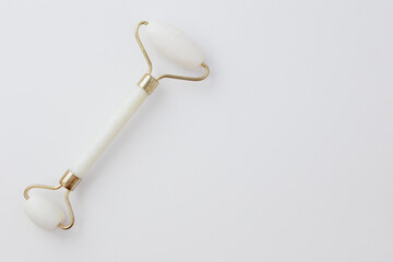 Top view of massage face tool on white background with copy space