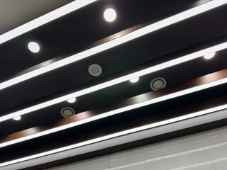 Lights and ventilation system in long line on ceiling of the  industrial building. Exhibition Hall....
