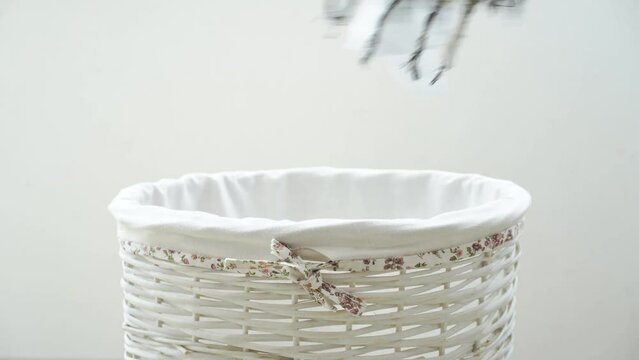 Female hand throwing clothes to the laundry basket. High quality 4k footage