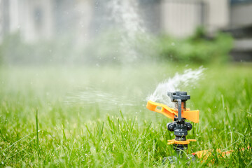 Automatic watering of grass with a rotating sprinkler