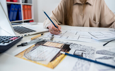 Caucasian young female architect working with home drawing plan  with architect equipment